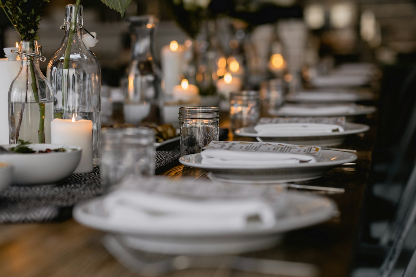 Warmly lit table set for a cozy dinner party.